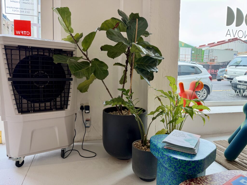 Medium evaporative air cooler positioned inside heritage showroom in Cape Town