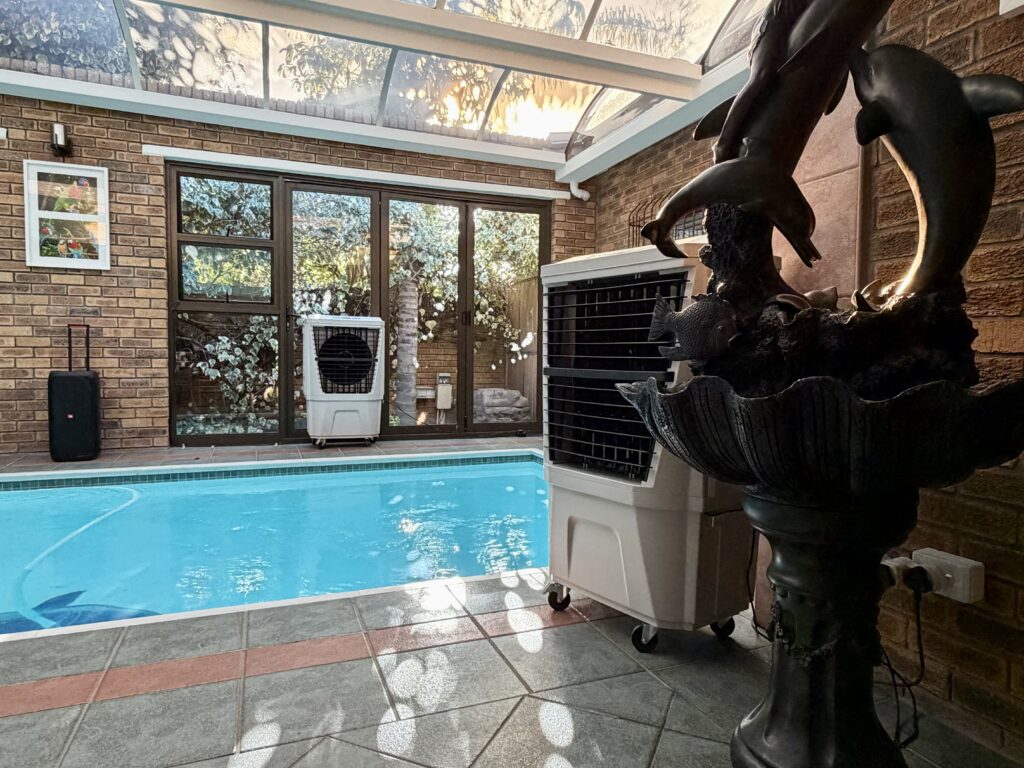 Indoor entertainment area cooling with evaporative air coolers